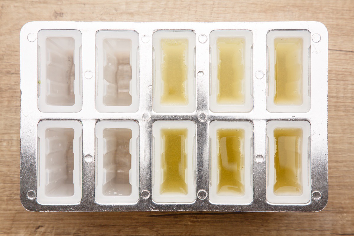 pour the pickle juice into popsicle molds