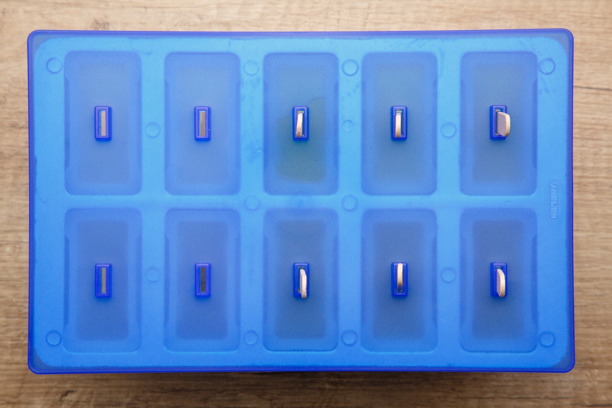 pickle popsicles in the popsicle molds with the cover on